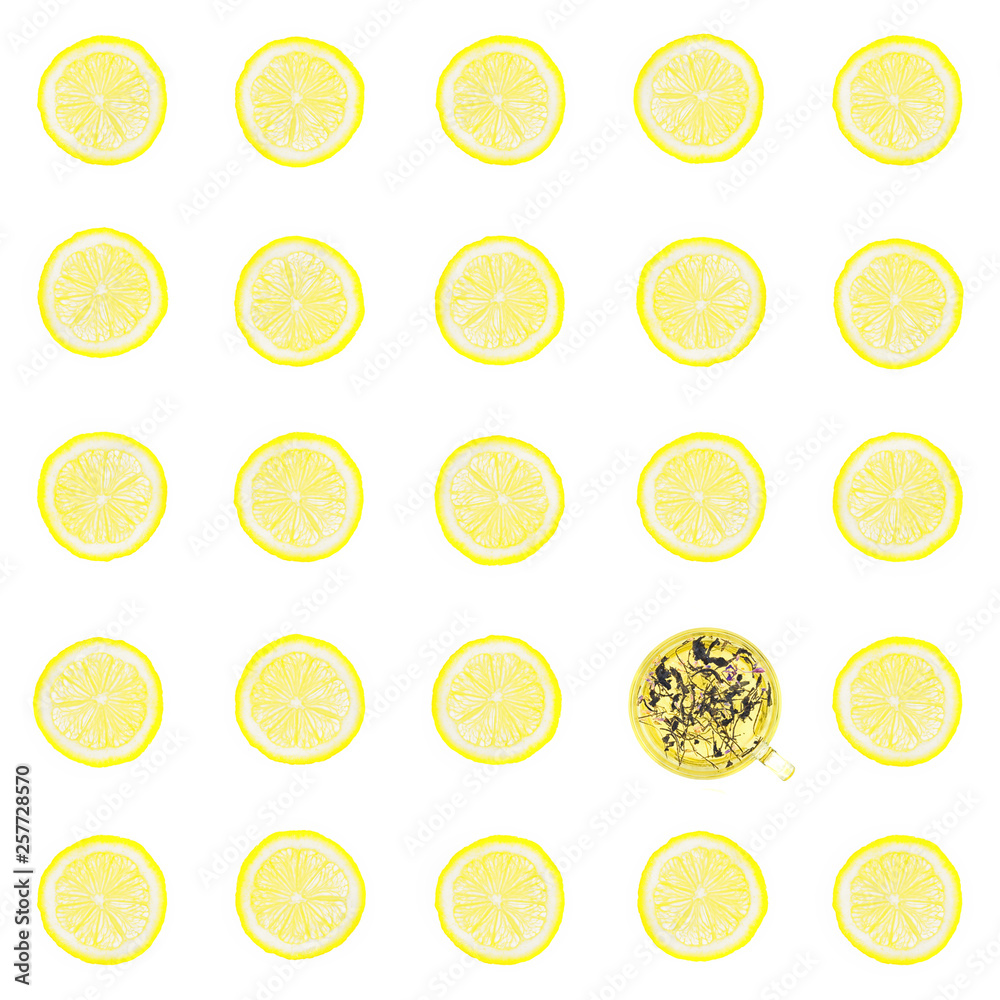 the solar circles of a lemon isolated on a white background and one glass cup with green tea the solar circles of a lemon isolated on a white background and one glass cup with green tea