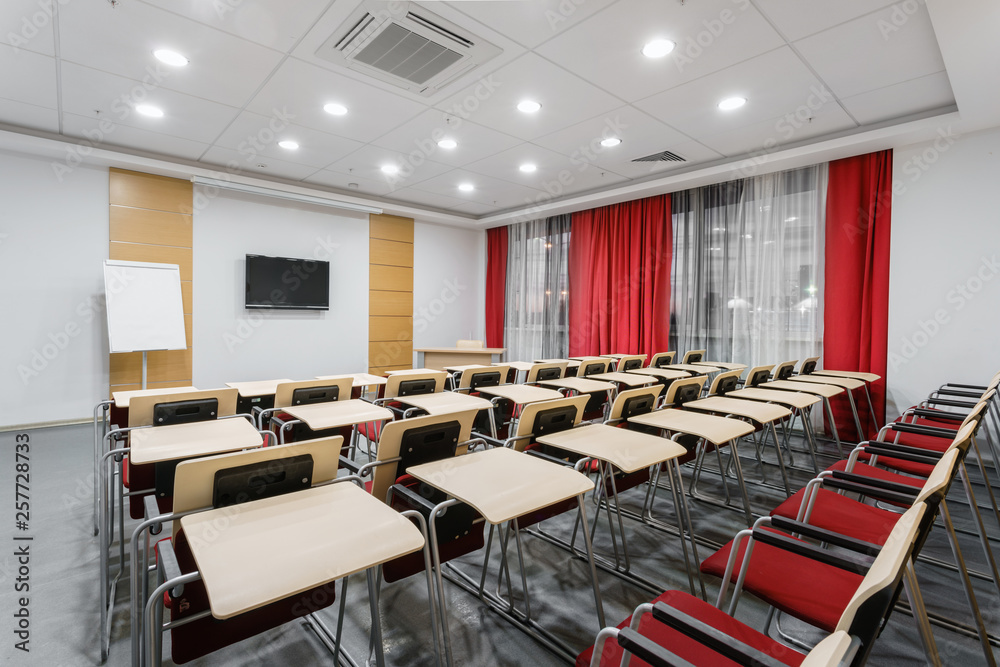 Empty modern conference hall in new hotel. Room for training, education, group classes, exams. Audience for Speakers at Business convention and Presentation. Empty modern conference hall in new hotel. Room for training, education, group classes, exams. Audience for Speakers at Business convention and Presentation.