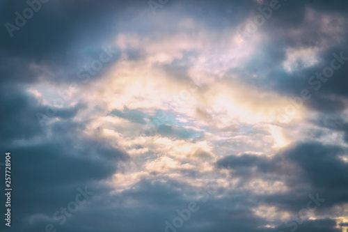 Blue sky among dark clouds