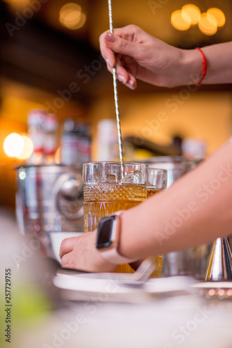 female bartender preparing cocktail in a cocktail bar