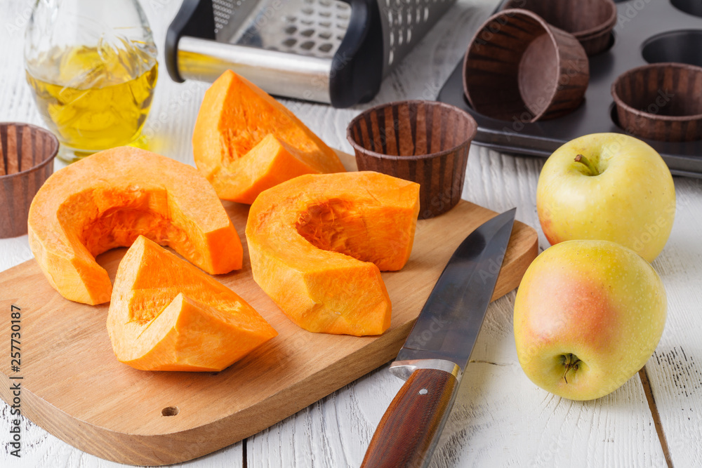 Fresh orange pumpkin, sliced and grated, prepare for cooking. Organic, seasonal, natural and healthy food concept