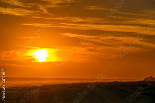 Golden sunset on the beach with the sun over the beach