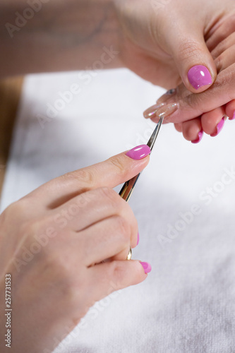 Closeup view of hands with manicure of young woman Nail treatment by a specialist in the salon