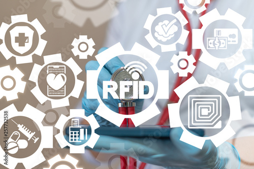 Doctor or druggist uses smartphone sees on a virtual screen of the future and touches the icon: rfid radio signal. RFID Radio Frequency Identification Communication Marketing Health Pharmacy System. photo