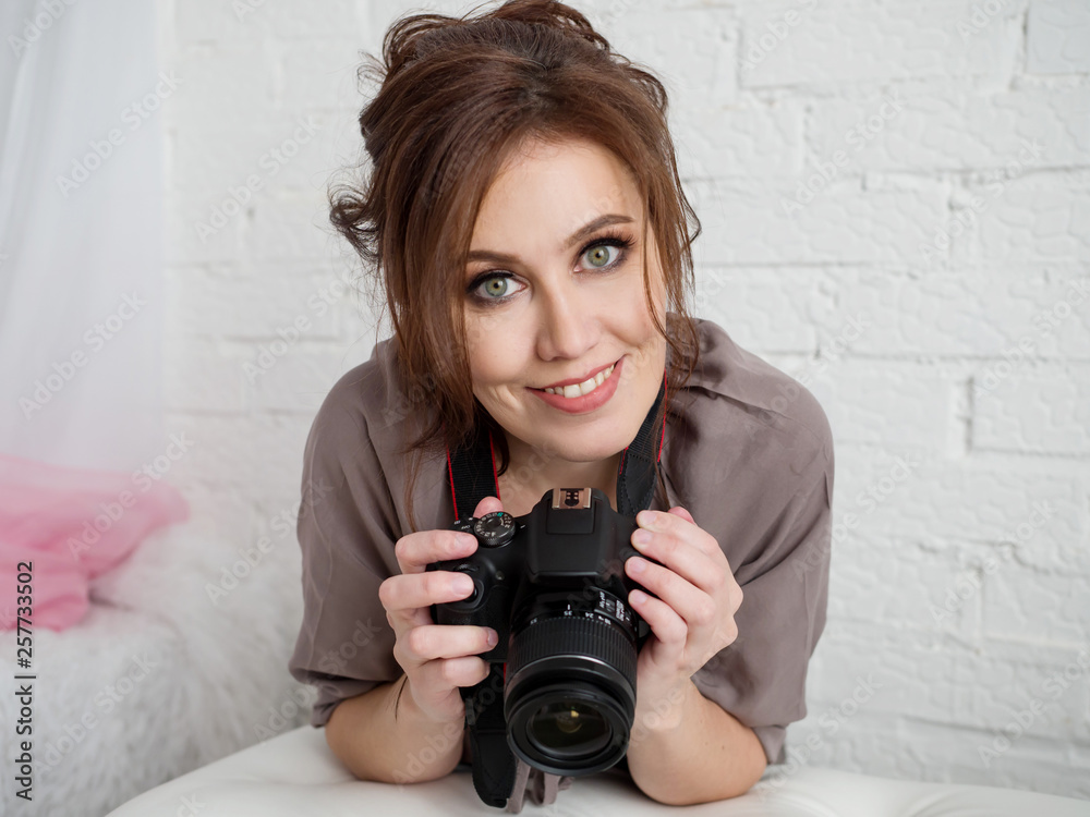 Beautiful happy girl with a camera in hand