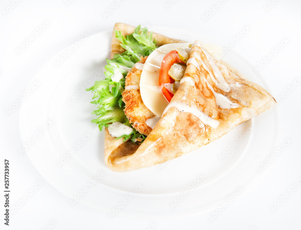 Thin delicious pancake with meat steak, cheese, tomato and greenery on white