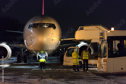 Passenger aircraft at night at airport. Airplane in winter at night at airport.