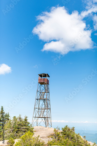 an old fire tower with a woman perched on top