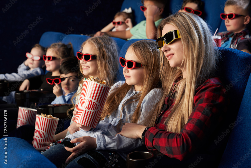 Crowd watching 3D movie in theatre.