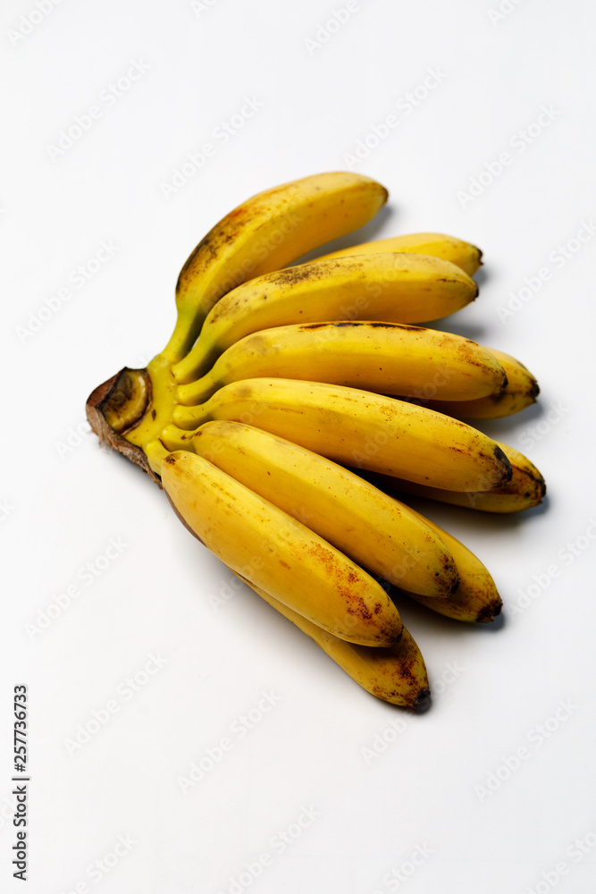 Yellow, ripe pass bananas with saturated aroma on a white background.
