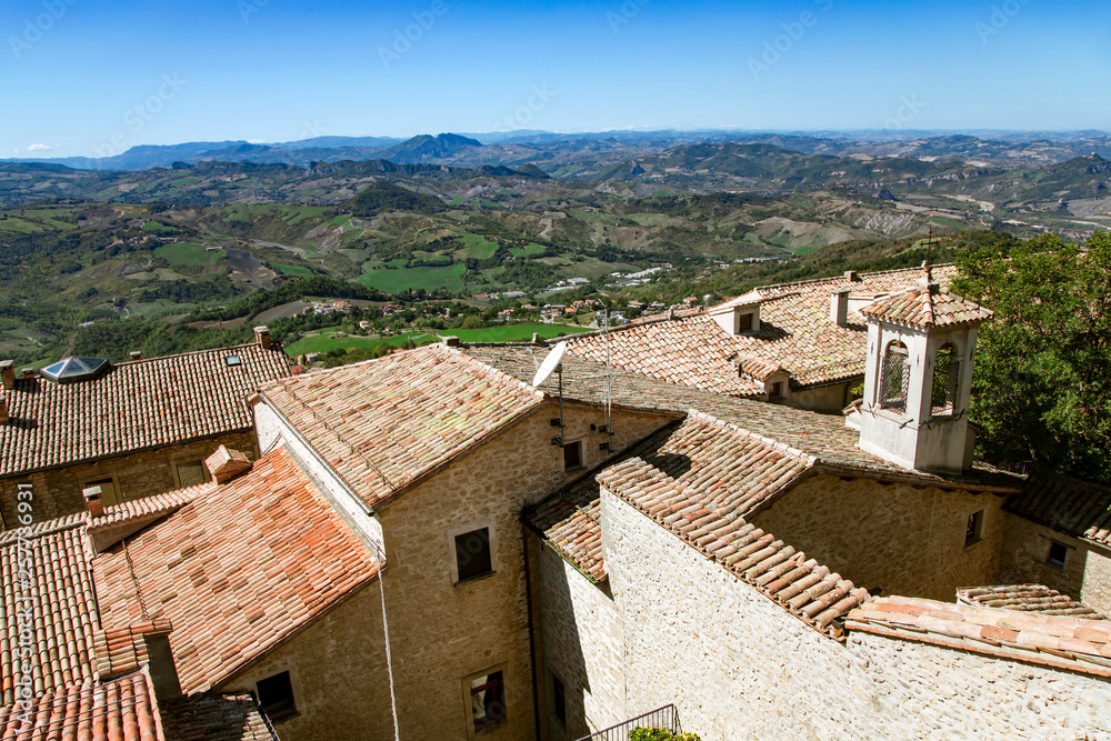 View of the multiple green hills from the observation deck of the old castle of the Republic of San Marino, Italy View of the multiple green hills from the observation deck of the old castle of the Republic of San Marino, Italy