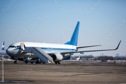 Passenger plane at airport in winter afternoon. plane on airport platform in winter. Airplane on summer strip in winter