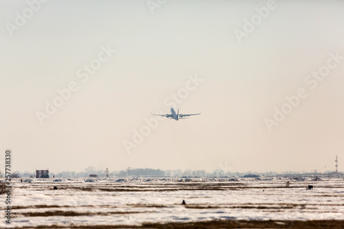 Passenger plane at airport in winter afternoon. plane on airport platform in winter. Airplane on summer strip in winter