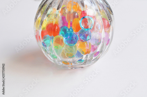 Beautiful round glass jar full of colorful water balls