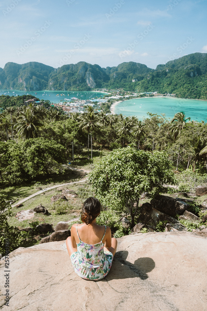 Koh Phi Phi Don, Viewpoint - Girl enjoying beautiful view of paradise bay from the top of the tropical island. View from the back. Thailand.