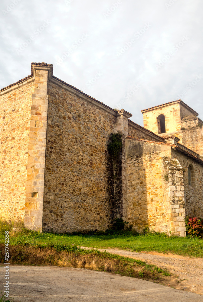 Facade of romaneque church in the north of Spain in rural town.