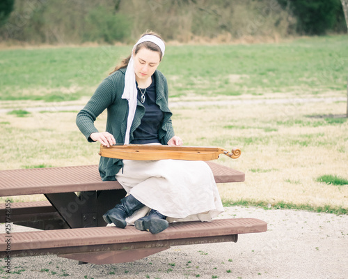 Girl Playing Mountain Dulcimer in Park