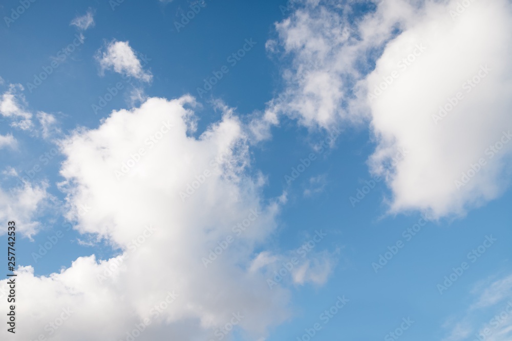 Beautiful white fluffy clouds on a blue sky background