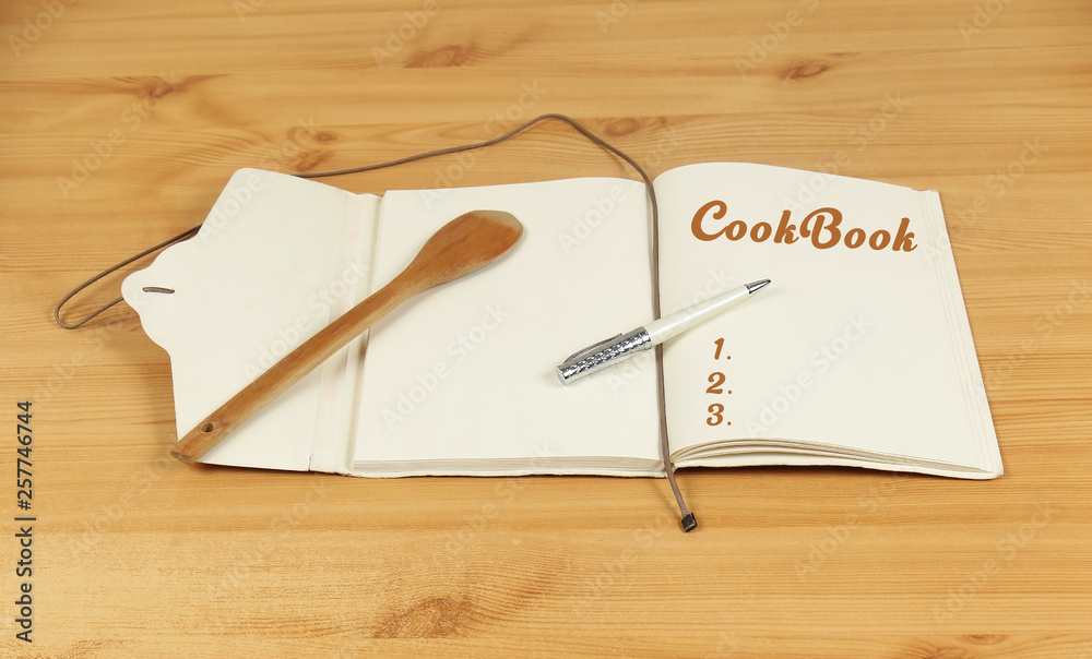 Cookbook with wooden spoon Cookbook with wooden spoon