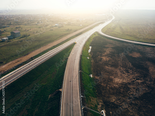 Aerial view of modern new highway road with transportation junction for traffic