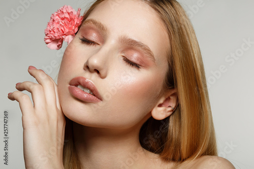 Beautiful young woman with eyes closed, perfect skin