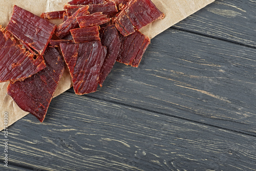 Konstfotografi Beef jerky on a wooden board, close-up.