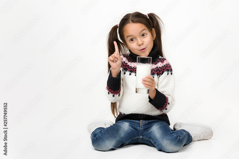 Portrait of cute little child girl holding glass of milk isolated on white. it is very useful! Portrait of cute little child girl holding glass of milk isolated on white. it is very useful!