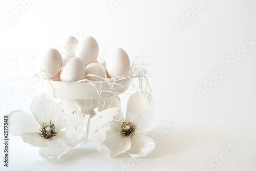 white romantic Easter scene  cake stand with eggs and flowers  against white background  space for text