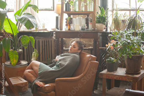 Εκτύπωση καμβά Side view of thoughtful woman wrapped in scarf looking away while relaxing on ar