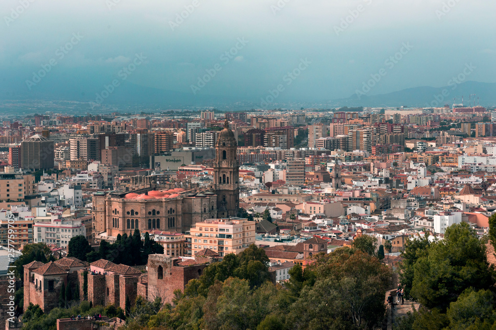 Malaga, Spain, February 2019. Panorama of the Spanish city of Malaga. Buildings  against a cloudy sky. Dramatic sky over the city. Beautiful view.