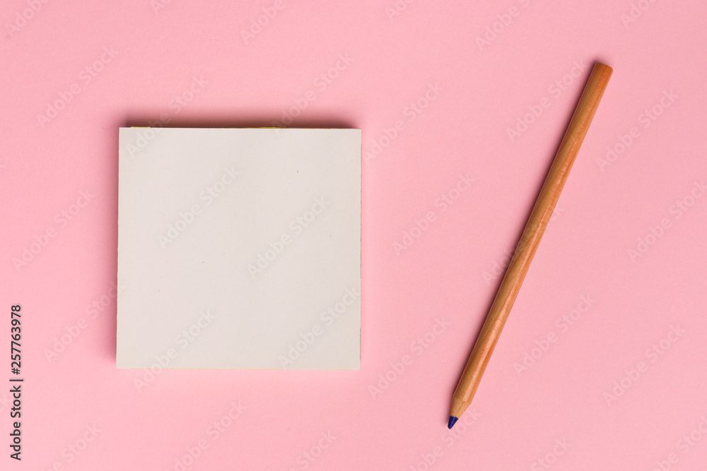 Top view flat lay picture with blank notepad page and pencil on colored surface Top view flat lay picture with blank notepad page and pencil on colored surface