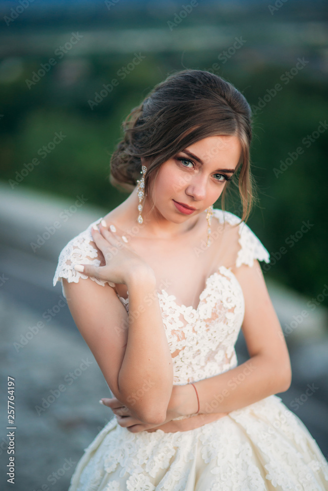 Elegant lady in white dress. Young model in evening dress Elegant lady in white dress. Young model in evening dress
