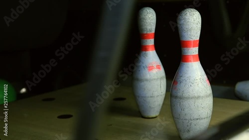 Bowling ball knocks down bowling pins in slow motion reflection destroy alley game pin sport fun group hobby lane leisure strike bowl success team ten arrangement background loseup competition