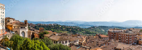 Perugia aerial cityscape panorama in Umbria, Italy skyline view of church tower and rooftops of town village in summer landscape