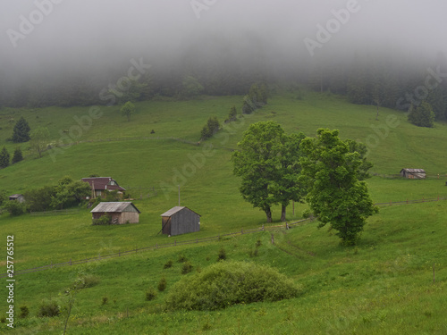 Mountain landscape in the fog. house in the mountains.