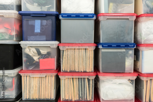 Schilderij op canvas Stacked plastic file storage boxes with folders, binders and miscellaneous items