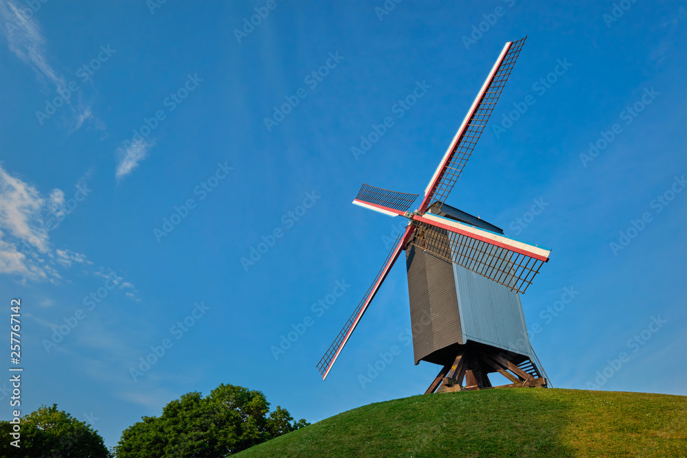 Fototapeta premium Sint-Janshuismolen Sint-Janshuis Mill windmill in Bruges on sunset, Belgium