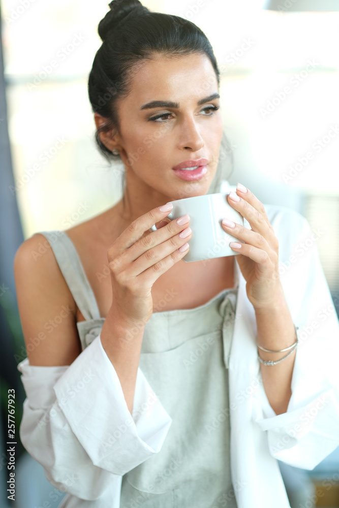Adult woman chilling at her house with cup of coffee. Adult woman chilling at her house with cup of coffee.