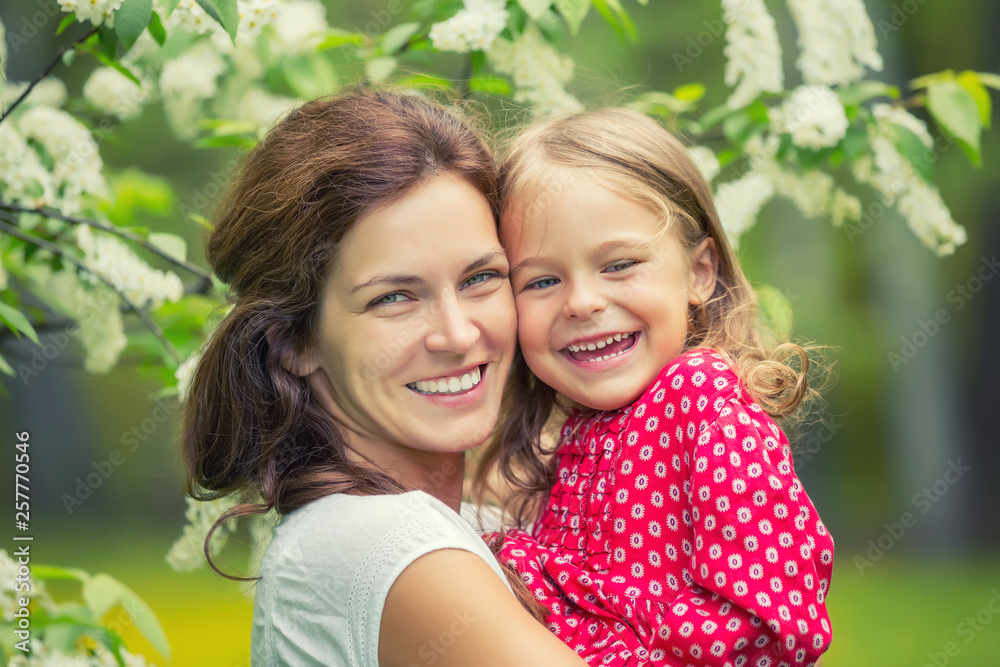 Portrait of happy mother and little daughter in spring park Portrait of happy mother and little daughter in spring park
