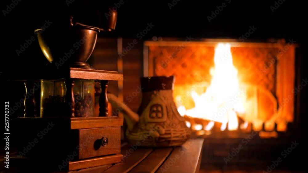 Fireplace and coffee grinder. Home mood.. Background Fireplace and coffee grinder. Home mood.. Background