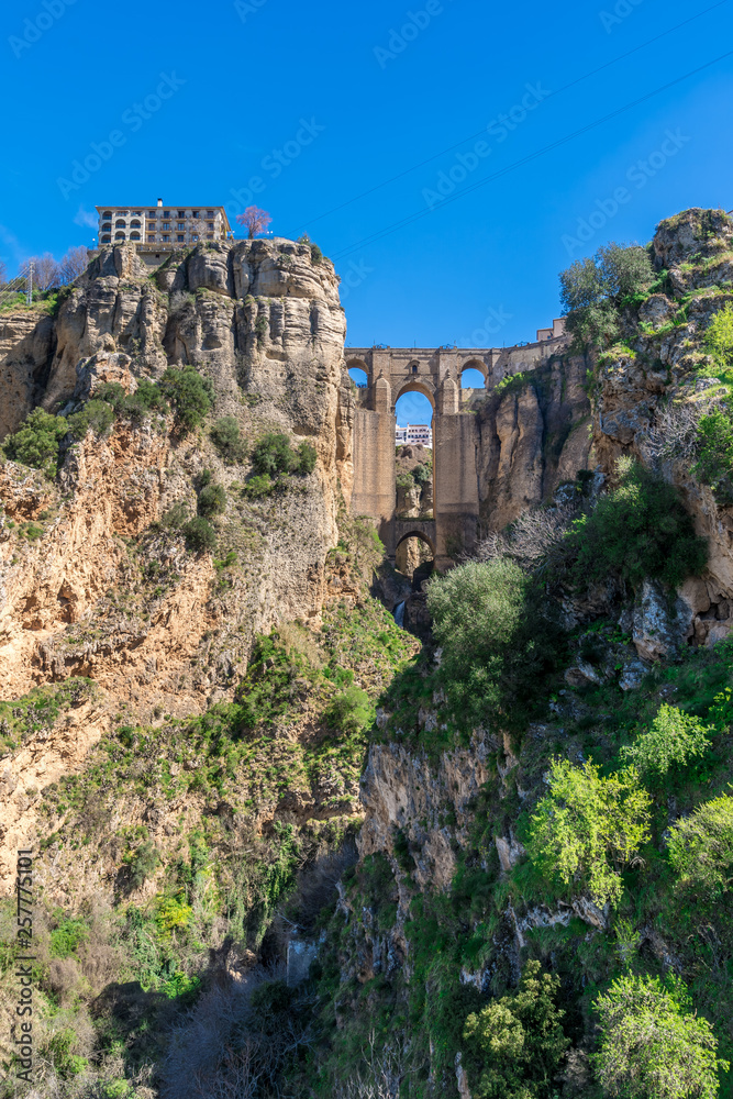 Ronda Spain aerial view of medieval hilltop town surrounded by walls and towers with famous bridge over gorge