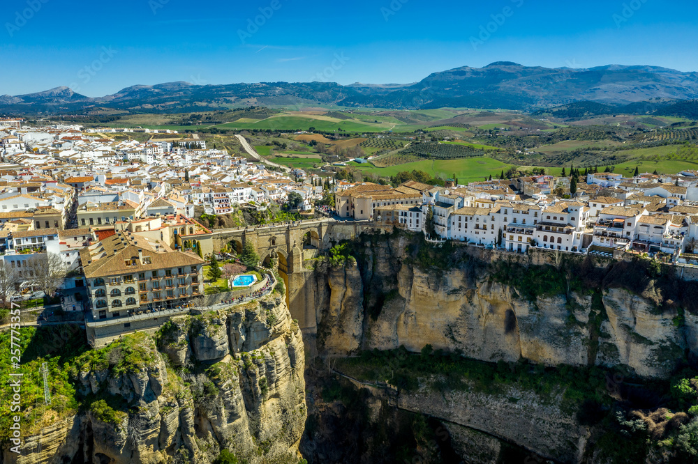 Fototapeta premium Ronda Spain aerial view of medieval hilltop town surrounded by walls and towers with famous bridge over gorge