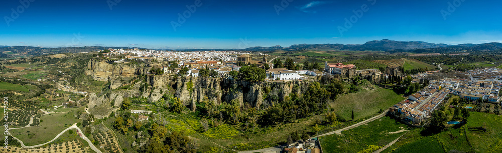 Ronda Spain aerial view of medieval hilltop town surrounded by walls and towers with famous bridge over gorge