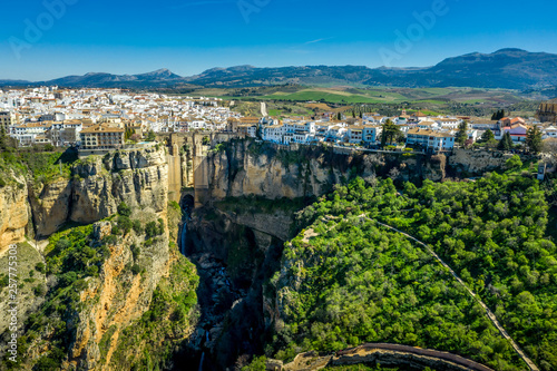 Fototapeta Naklejka Na Ścianę i Meble -  Ronda Spain aerial view of medieval hilltop town surrounded by walls and towers with famous bridge over gorge