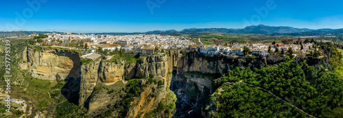 Ronda Spain aerial view of medieval hilltop town surrounded by walls and towers with famous bridge over gorge