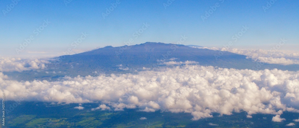 Fototapeta premium Scenic Landscape view from plane, clouds, sky, mountain, volcano, plaines