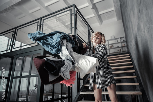 Wife throwing clothes of husband away from her apartment