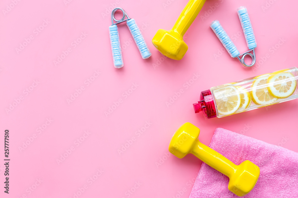Fitness background with sport equipment for gym and home on pink background top view copyspace Fitness background with sport equipment for gym and home on pink background top view copyspace