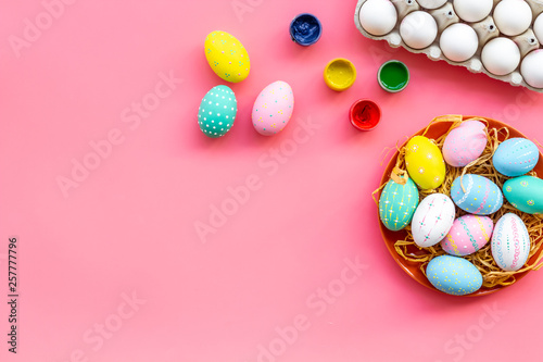 eggs with colorful paint for easter tradition on pink background top view mockup