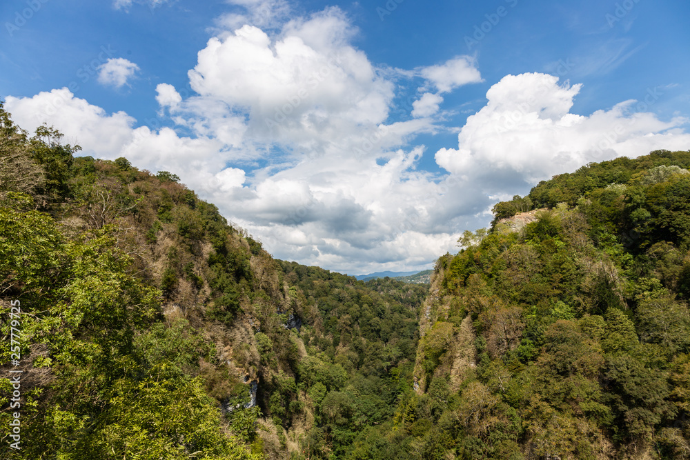Canyon in the mountains through which flows a small mountain river, Krasnodar region, Russia Canyon in the mountains through which flows a small mountain river, Krasnodar region, Russia